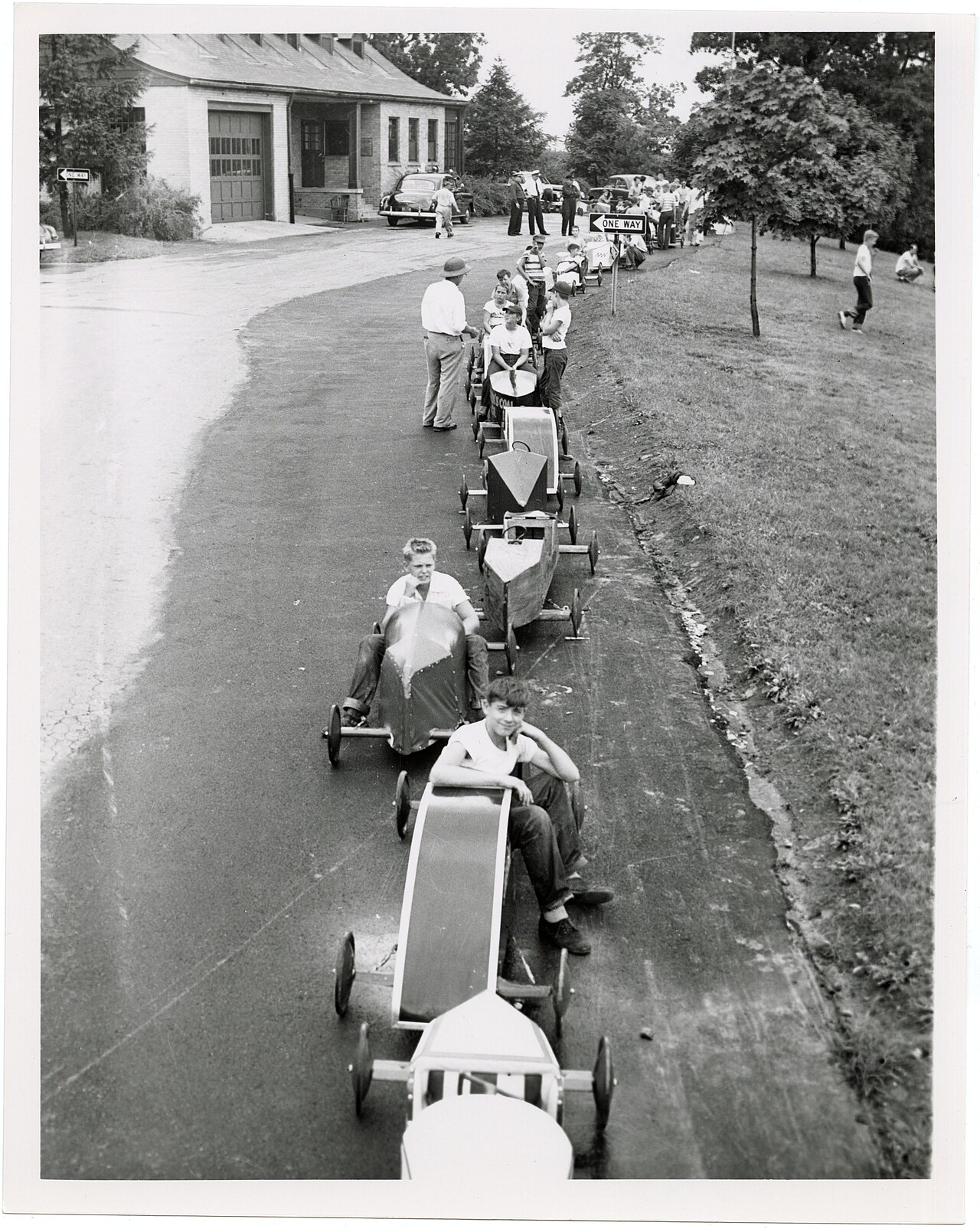 Young Soap Box Derby racers standing with their hand-built cars outside the Grandview municipal building in 1953